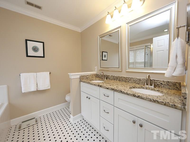 9112 Cub Trail Raleigh, NC 27615 - Photo 9 of 13 a bathroom with a granite countertop sink and a mirror