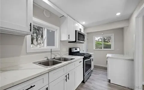 a kitchen that has a sink and a stove in it