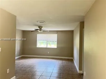 a kitchen with granite countertop a refrigerator and a sink
