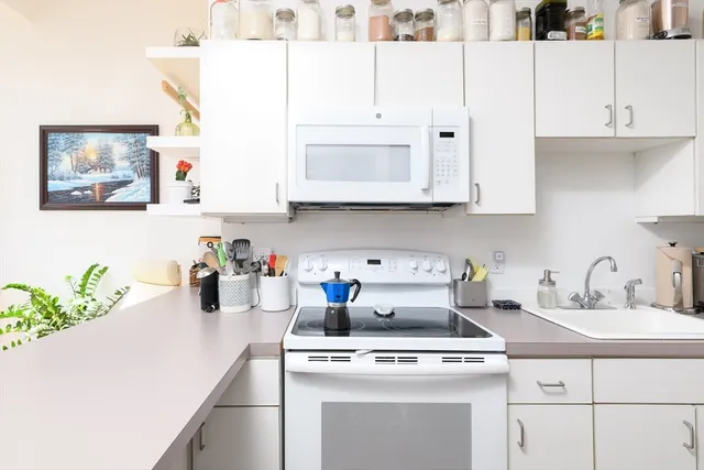 a kitchen with cabinets appliances and a counter top space