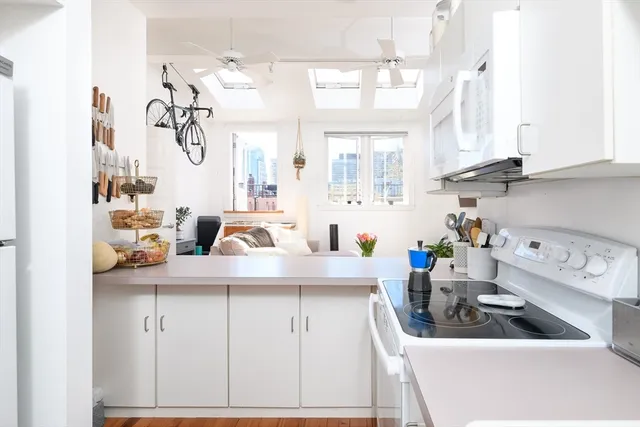 a kitchen with sink a stove and cabinets