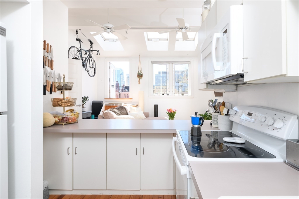 261 Marlborough Street, Unit 11 Boston, MA 02116 - Photo 6 of 17 a kitchen with sink a stove and cabinets