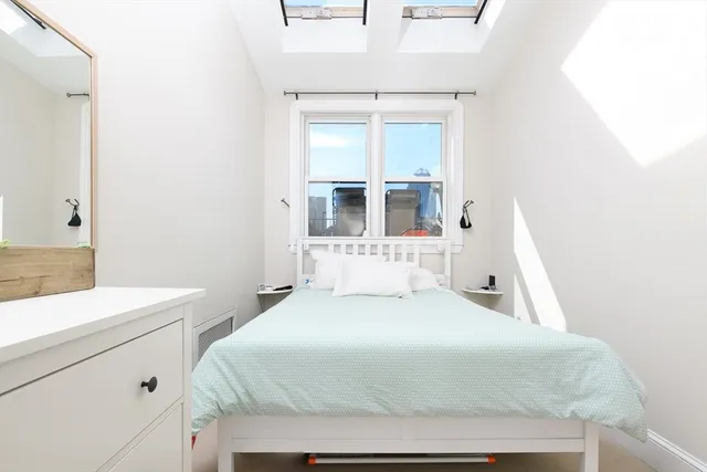 a bedroom with a bed and a mirror