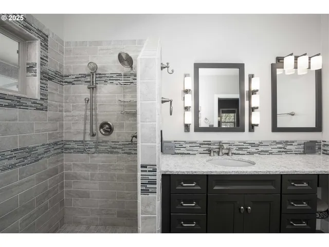 a bathroom with a sink vanity granite and a mirror