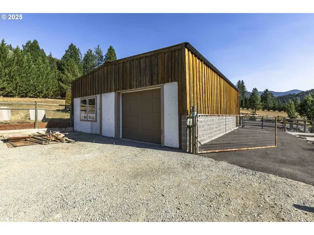 a view of empty room with wooden floor and furniture