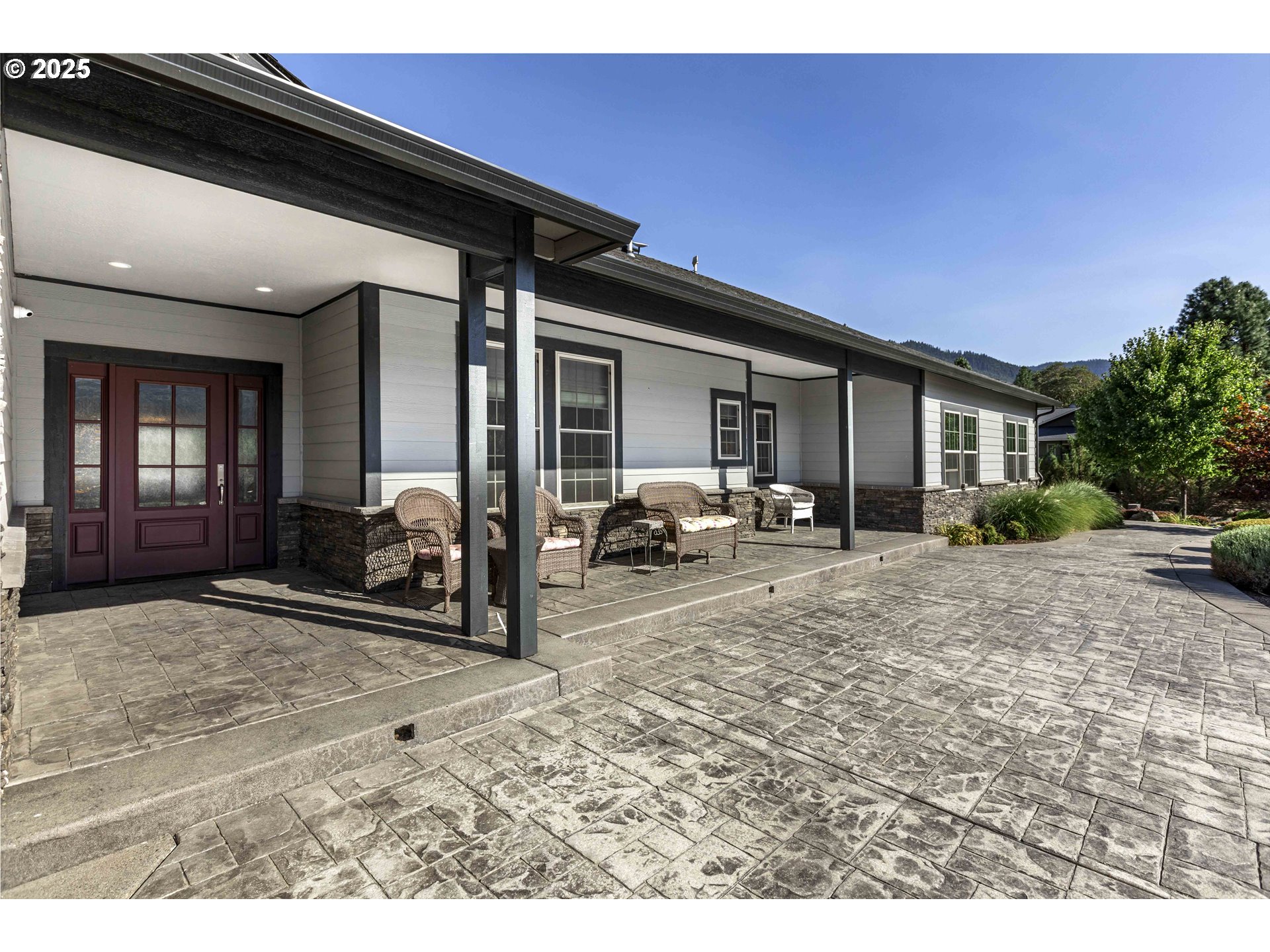 3465 Galls Creek Road Gold Hill, OR 97525 - Photo 3 of 30 a view of a patio with table and chairs and floor to ceiling window