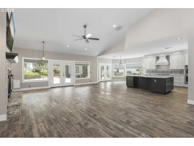 a view of kitchen and hall with wooden floor