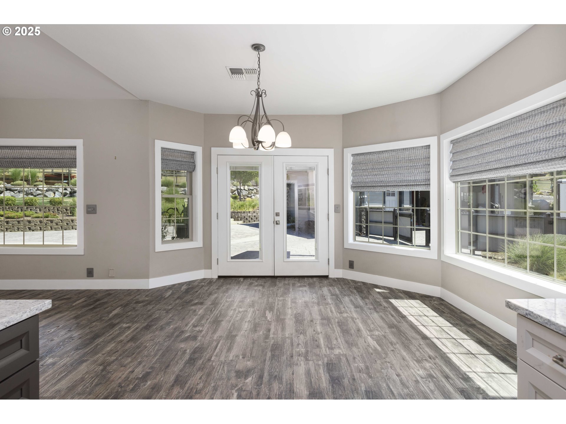 3465 Galls Creek Road Gold Hill, OR 97525 - Photo 10 of 30 a view of an empty room with wooden floor and a window