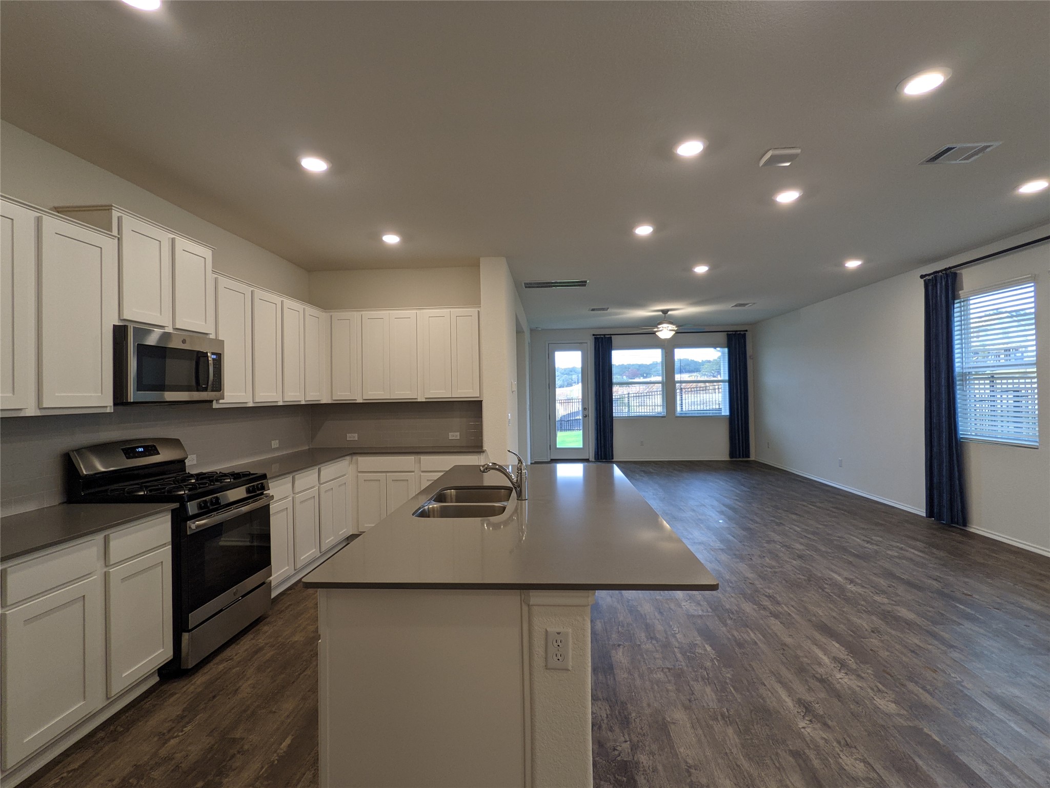 100 Montauk Loop Georgetown, TX 78628 - Photo 4 of 21 An open concept design seamlessly connects the kitchen with a spacious living area, ideal for entertaining.