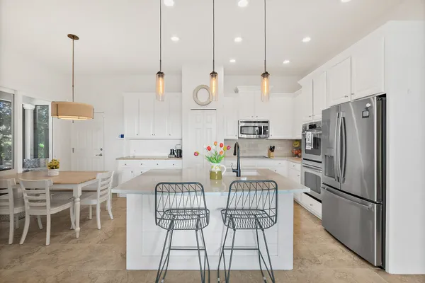 a living room with furniture and a floor to ceiling window