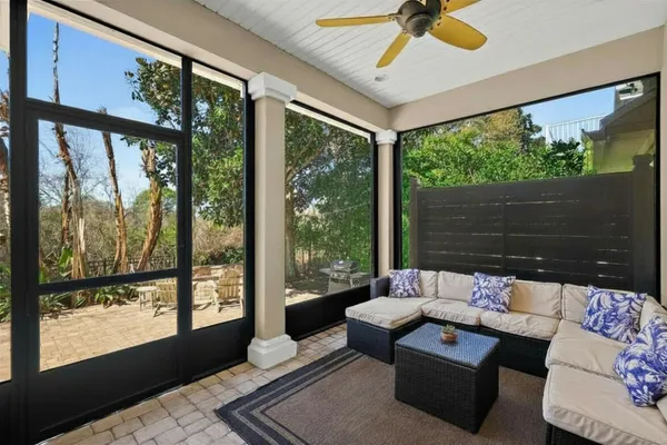 a view of a chair and tables in the back yard of the house