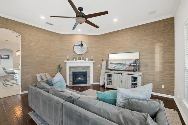 a kitchen with stainless steel appliances kitchen island granite countertop a dining table chairs and a refrigerator