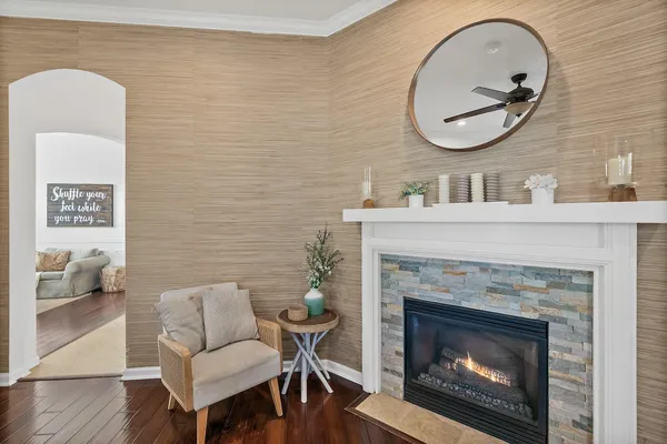 a living room with stainless steel appliances furniture and wooden floor