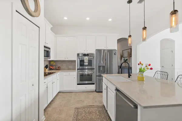a view of a patio with table and chairs and potted plants