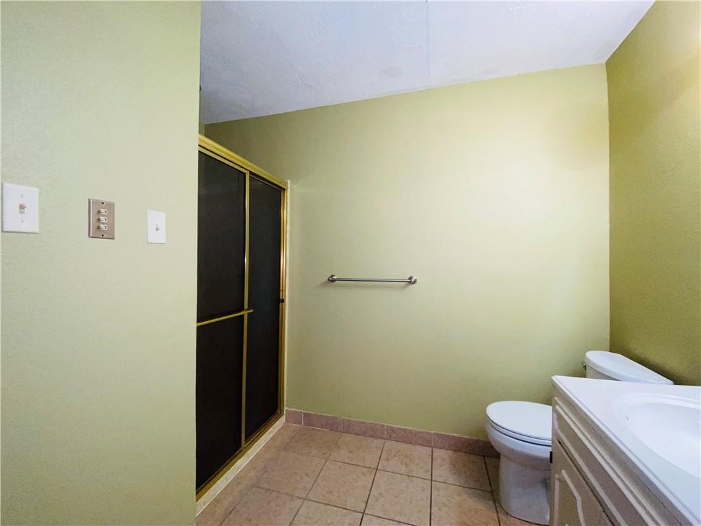 310 Sunset Boulevard Portland, TX 78374 - Photo 10 of 18 a bathroom with a toilet and a shower