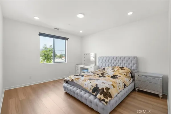 a bed sitting in a bedroom next to a window