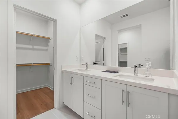 a bathroom with a double vanity sink and mirror