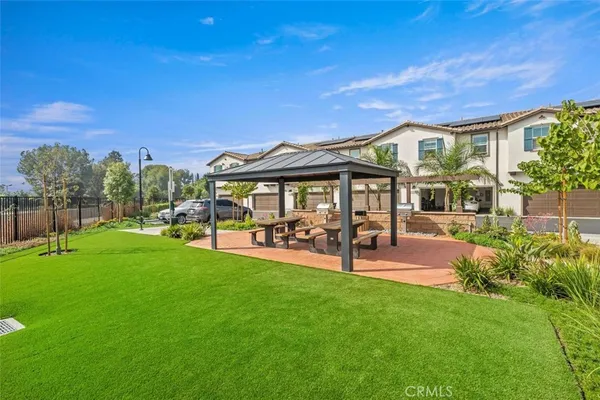 a view of a house with patio and a yard