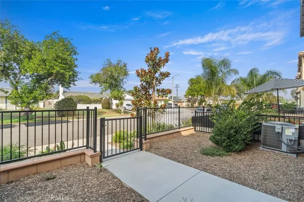 a view of a pathway with a wrought fence