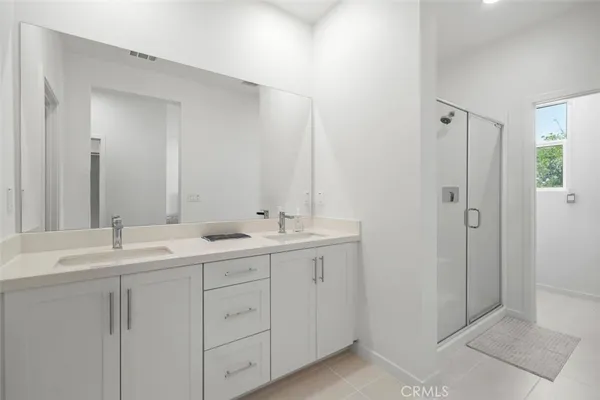 a bathroom with 2 sink tub and a mirror