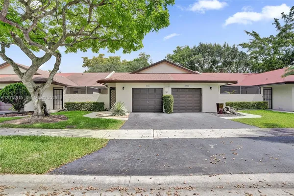 a front view of a house with a yard and a garage