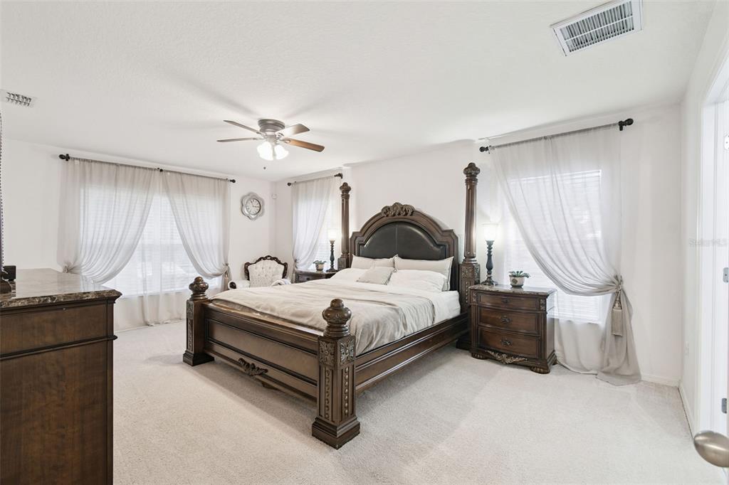 270 Planter Road Spring Hill, FL 34606 - Photo 15 of 33 a bedroom with bed and a chandelier