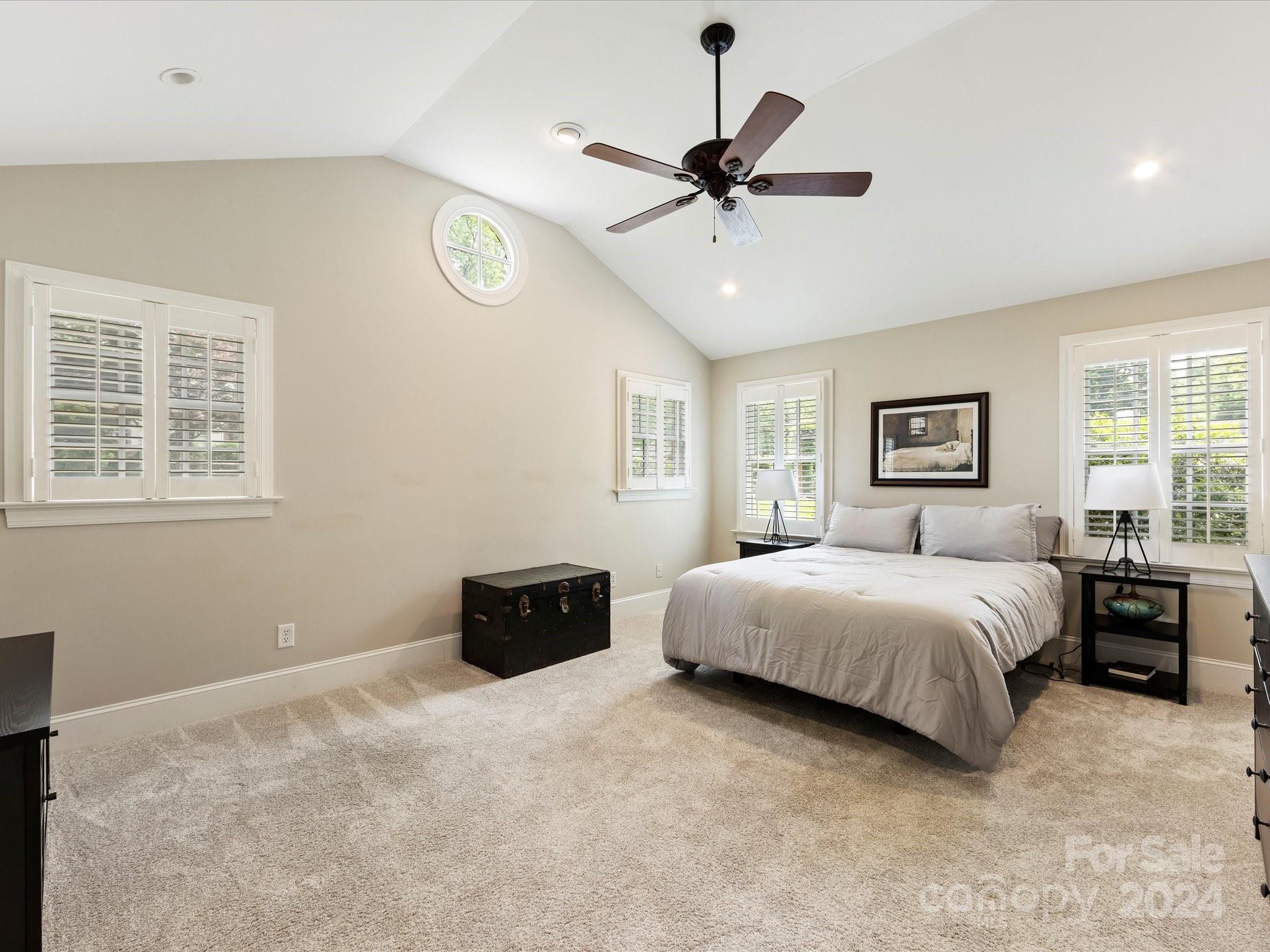 3200 Wickersham Road Charlotte, NC 28211 - Photo 15 of 35 a spacious bedroom with a bed and a chandelier