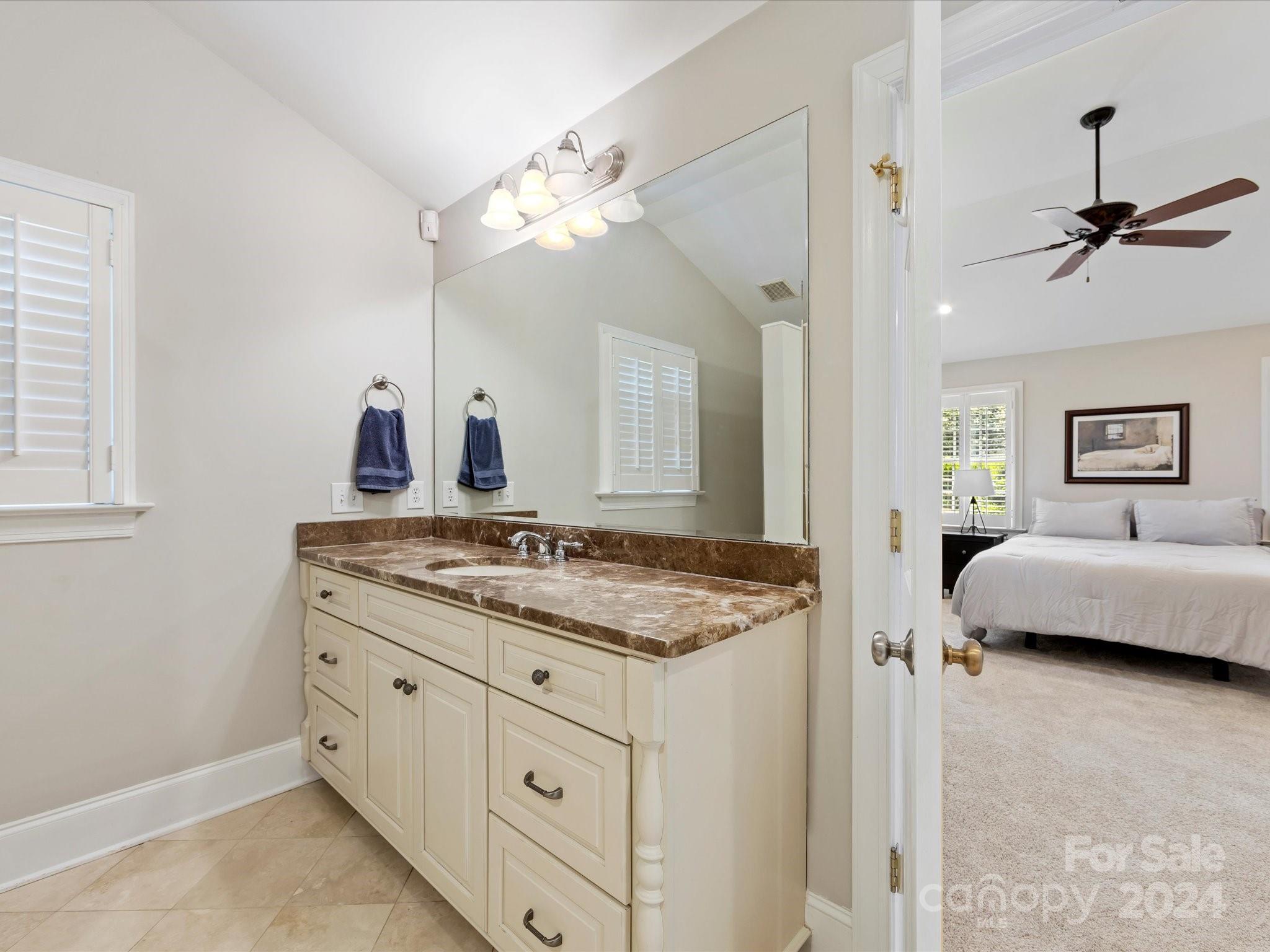 3200 Wickersham Road Charlotte, NC 28211 - Photo 18 of 35 a en suite bathroom with a granite countertop sink a mirror and shower
