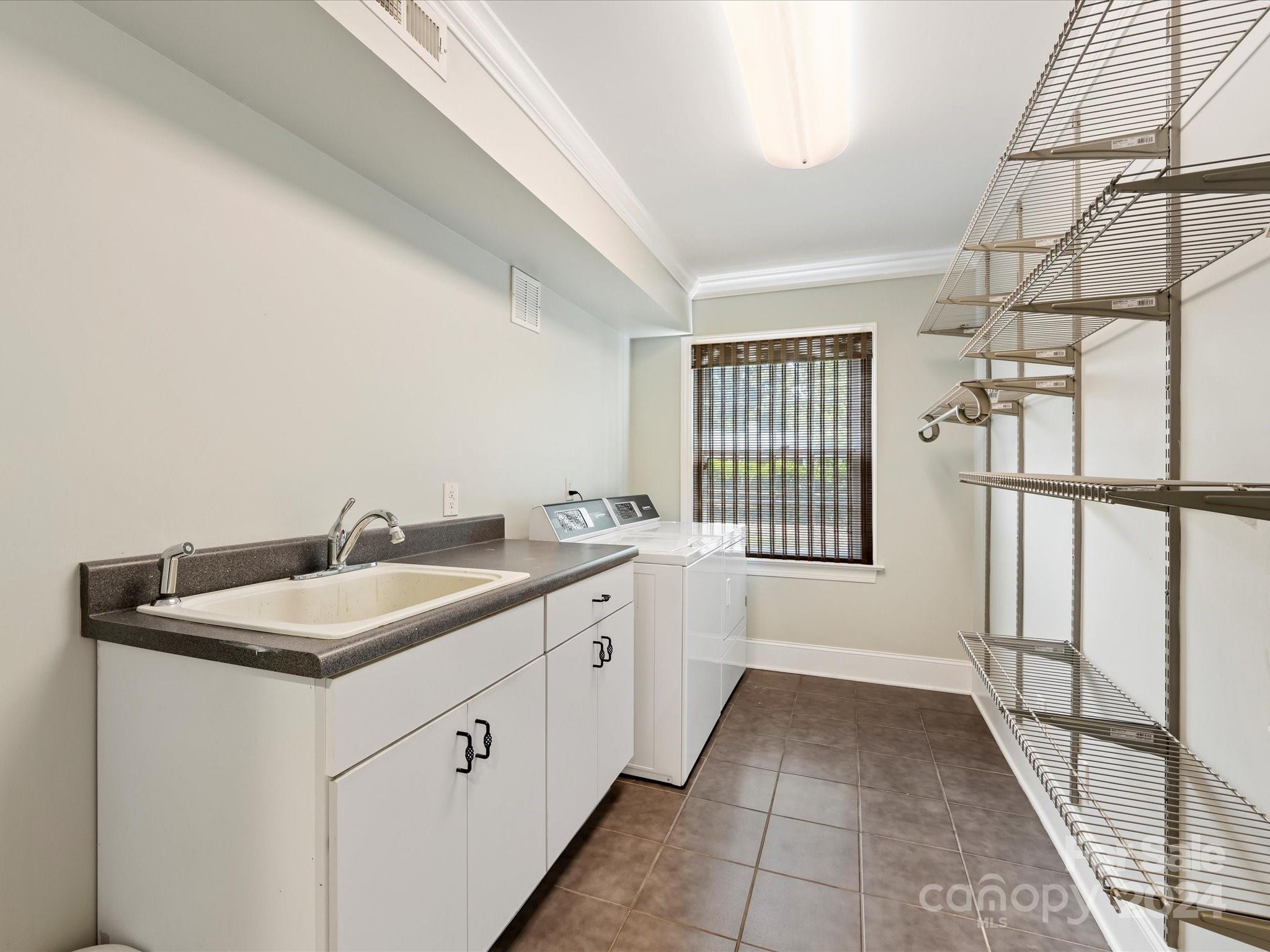 3200 Wickersham Road Charlotte, NC 28211 - Photo 21 of 35 a view of a bathroom with sinks and a window