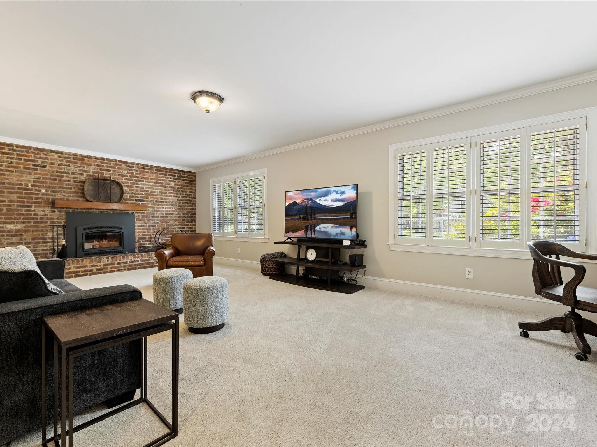 3200 Wickersham Road Charlotte, NC 28211 - Photo 22 of 35 a living room with furniture a fireplace and a flat screen tv