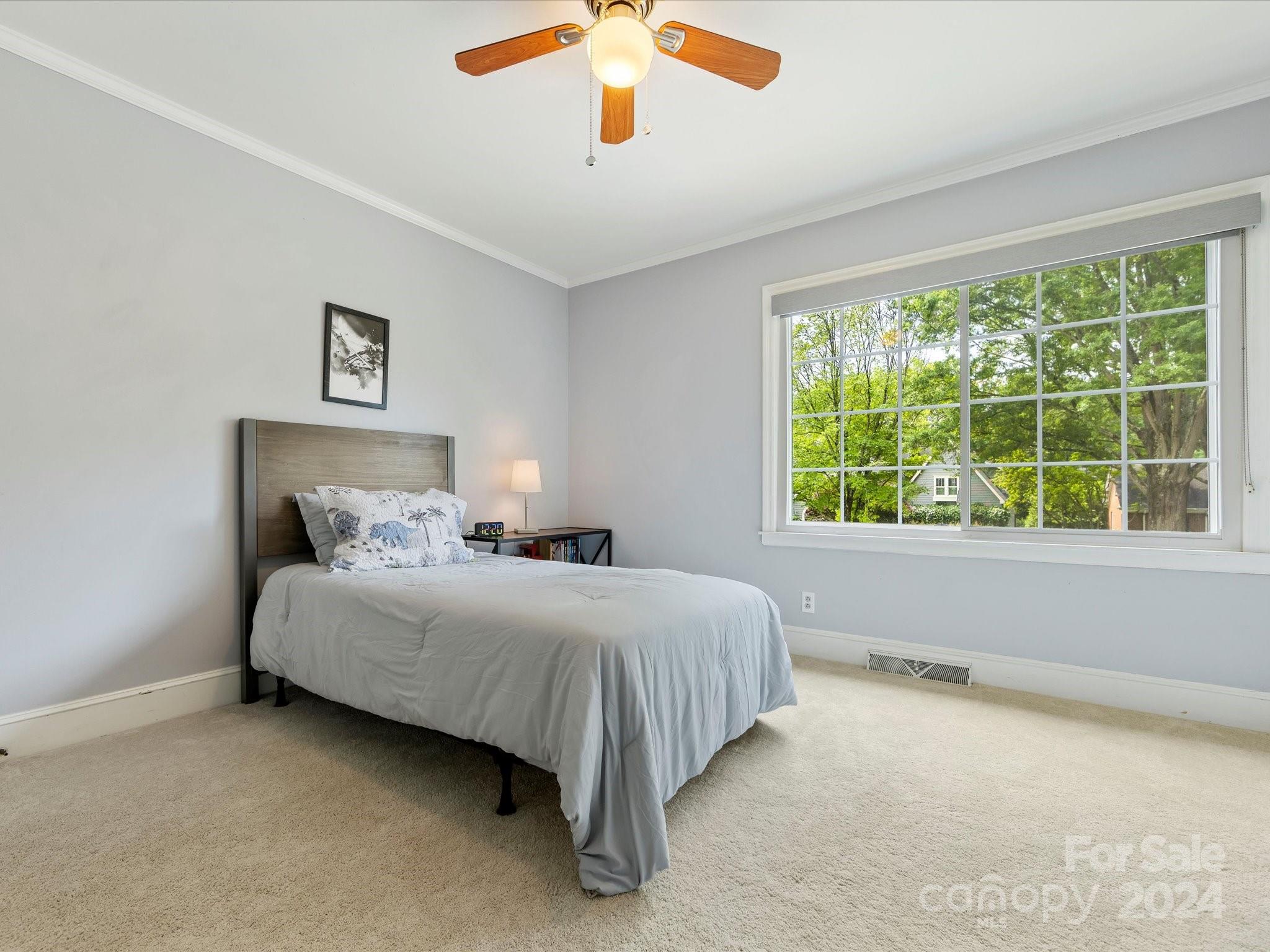 3200 Wickersham Road Charlotte, NC 28211 - Photo 24 of 35 a bedroom with a large bed and a large window