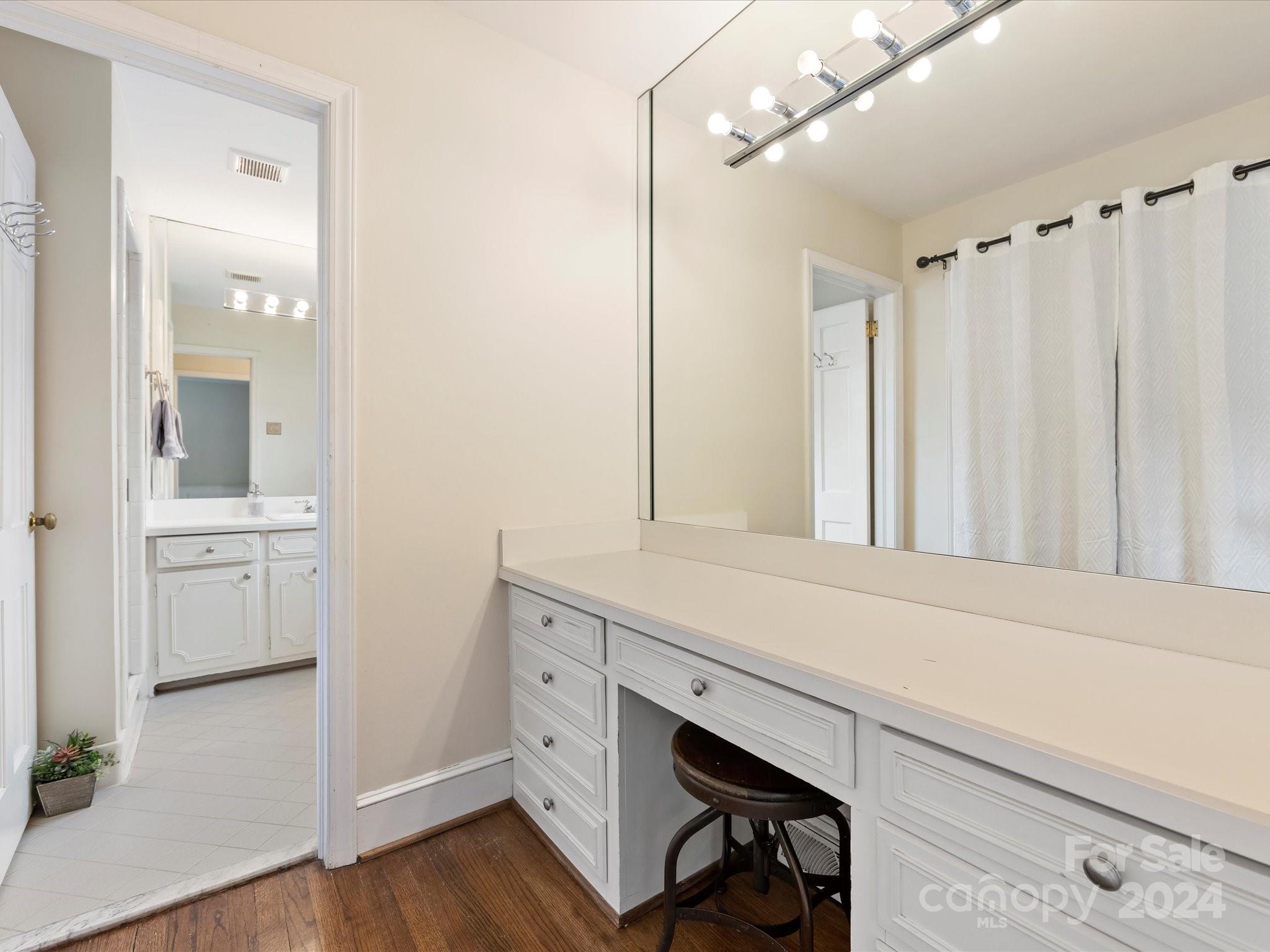 3200 Wickersham Road Charlotte, NC 28211 - Photo 28 of 35 a bathroom with a sink a mirror and a shower
