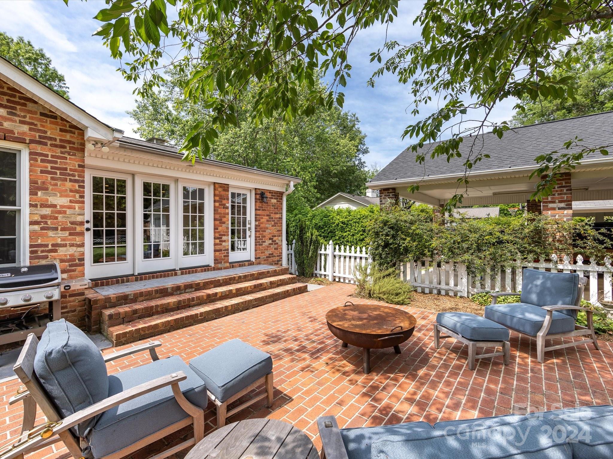3200 Wickersham Road Charlotte, NC 28211 - Photo 32 of 35 a view of a patio with table and chairs potted plants and large tree