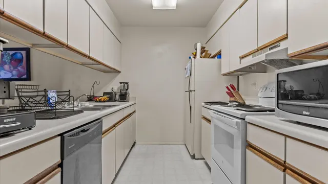 a kitchen with stainless steel appliances granite countertop a sink and a stove