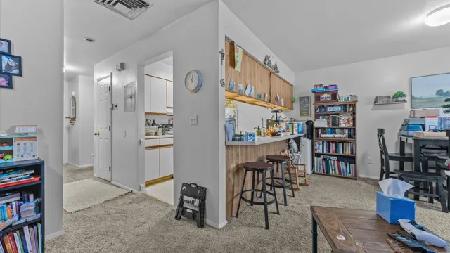 a view of a livingroom with furniture and an empty room