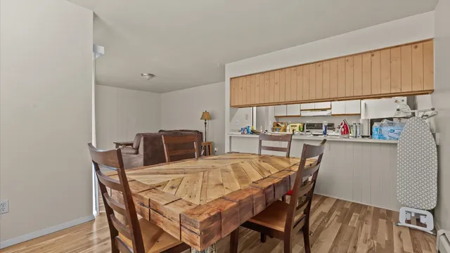 a dining room with furniture and a book shelf