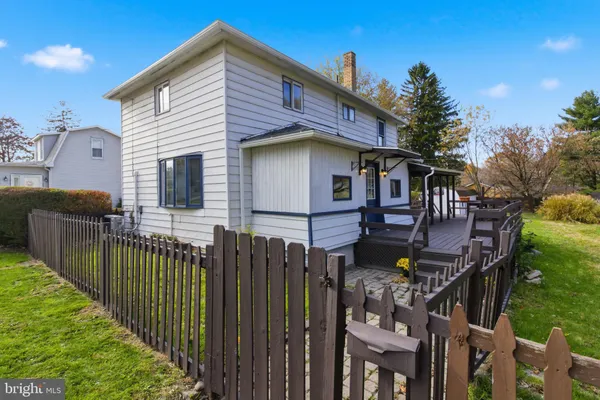 a view of a house with wooden fence
