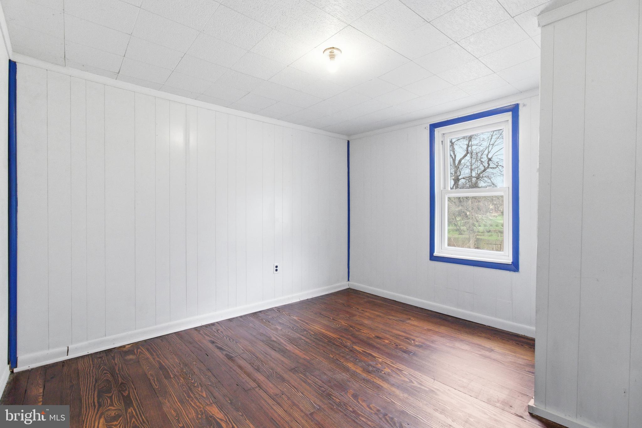 334 Hemlock Street Philipsburg, PA 16866 - Photo 16 of 16 an empty room with wooden floor and windows