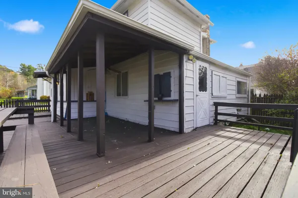 a view of a house with wooden deck