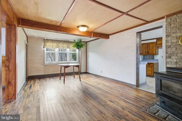 a view of a room with wooden floor and a window
