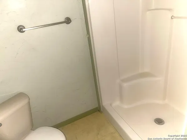 a bathroom with a shower and toilet