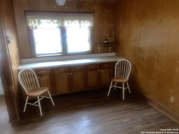 a view of a room with wooden floor and windows