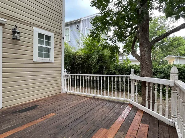 a balcony with wooden floor and fence