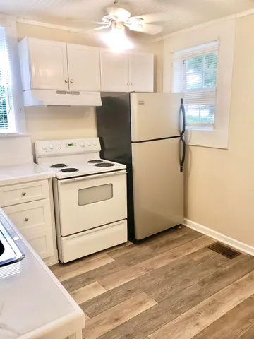 a kitchen with cabinets appliances and a counter space