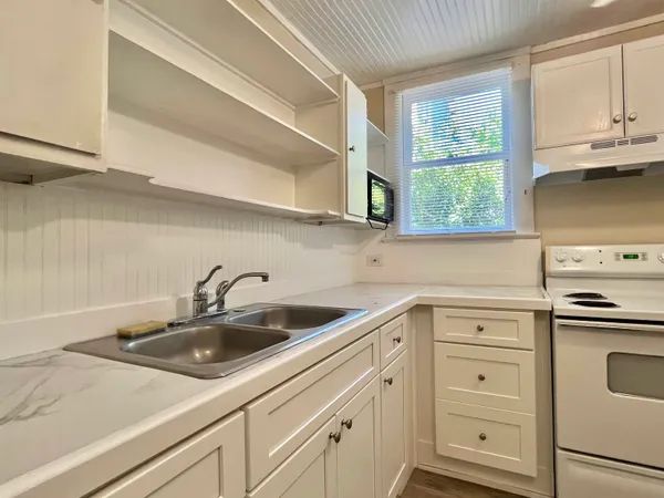 a kitchen with white cabinets and a sink