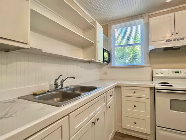 a kitchen with white cabinets and a sink