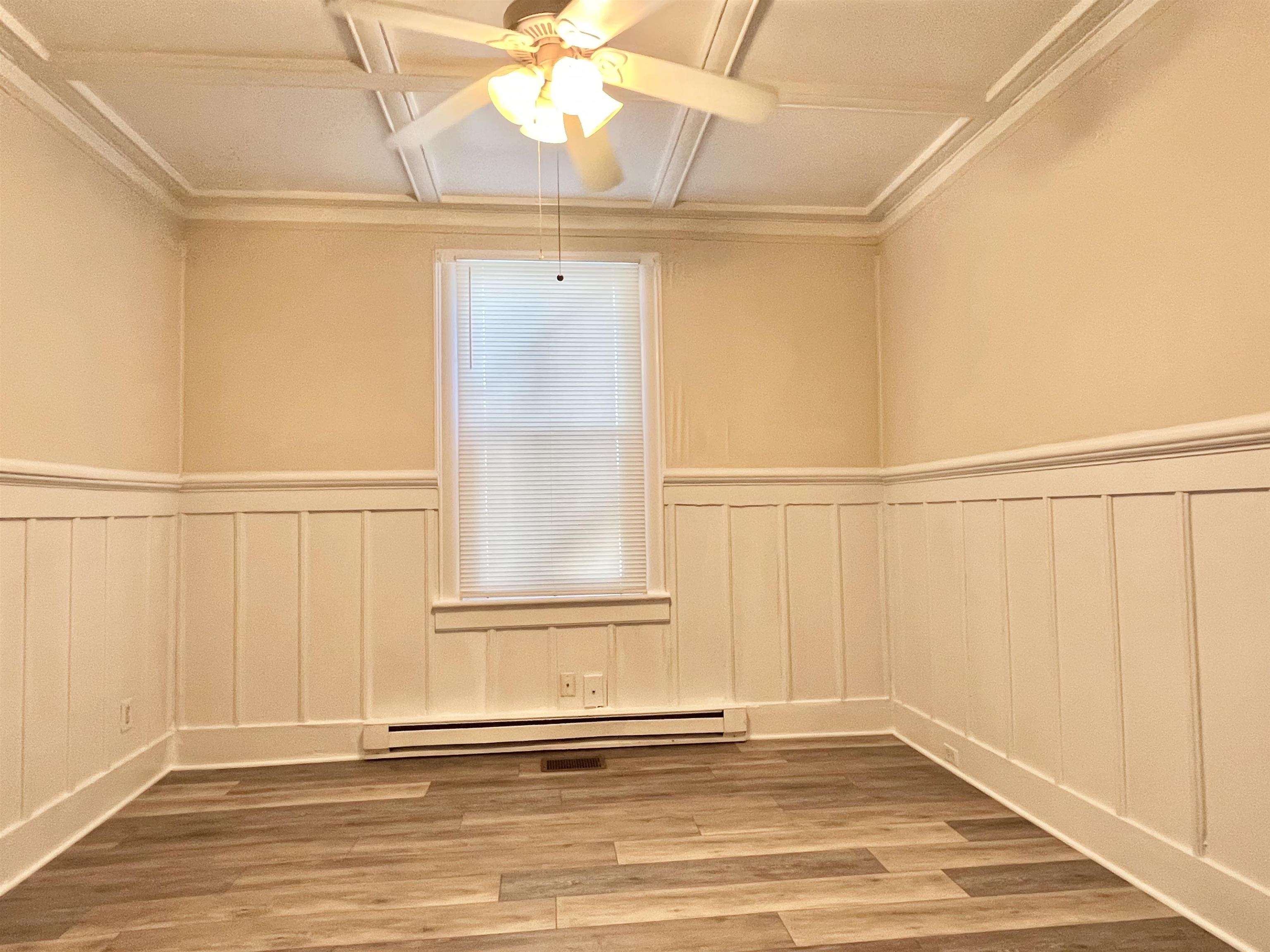 25 Desoto Place, Unit 1 St. Augustine, FL 32084 - Photo 6 of 12 an empty room with wooden floor fan and windows