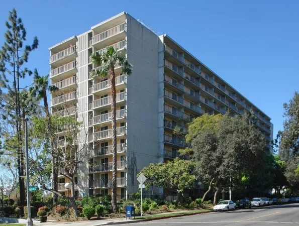 a view of a tall building next to a road