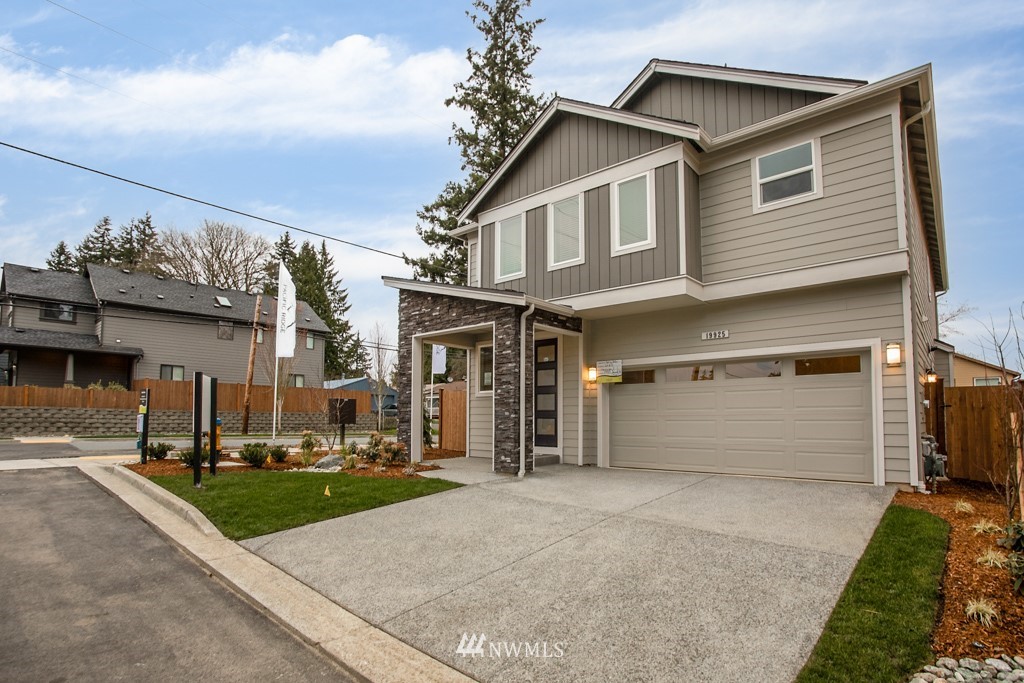 19925 Jewell Road, Unit 15 Bothell, WA 98012 - Photo 1 of 27 a front view of a house with a yard and garage
