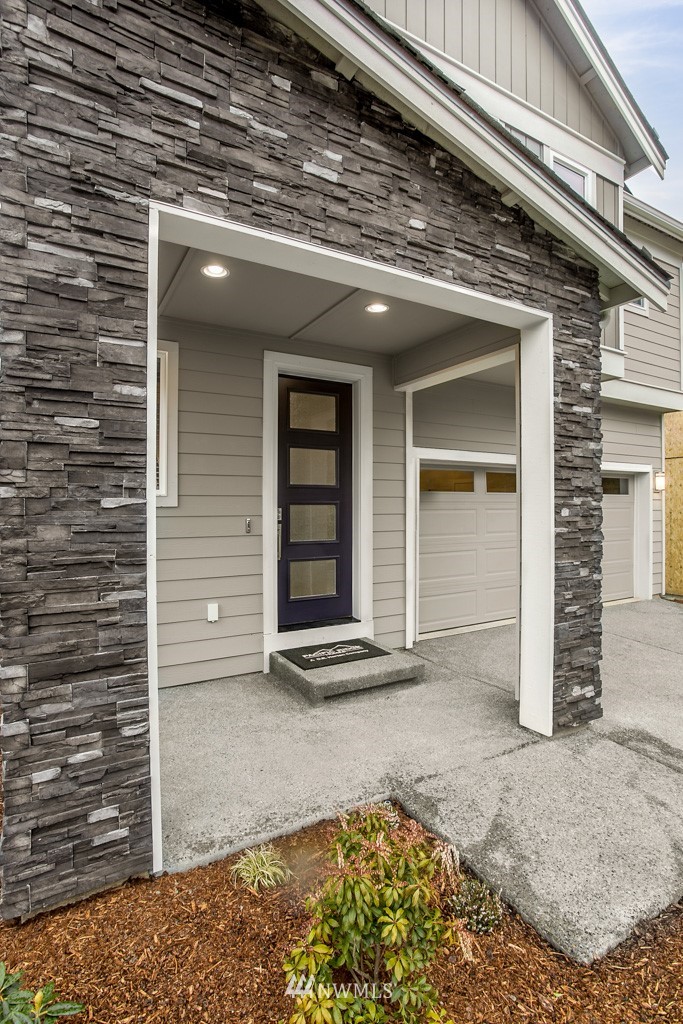 19925 Jewell Road, Unit 15 Bothell, WA 98012 - Photo 3 of 27 a view of yellow house with a large window